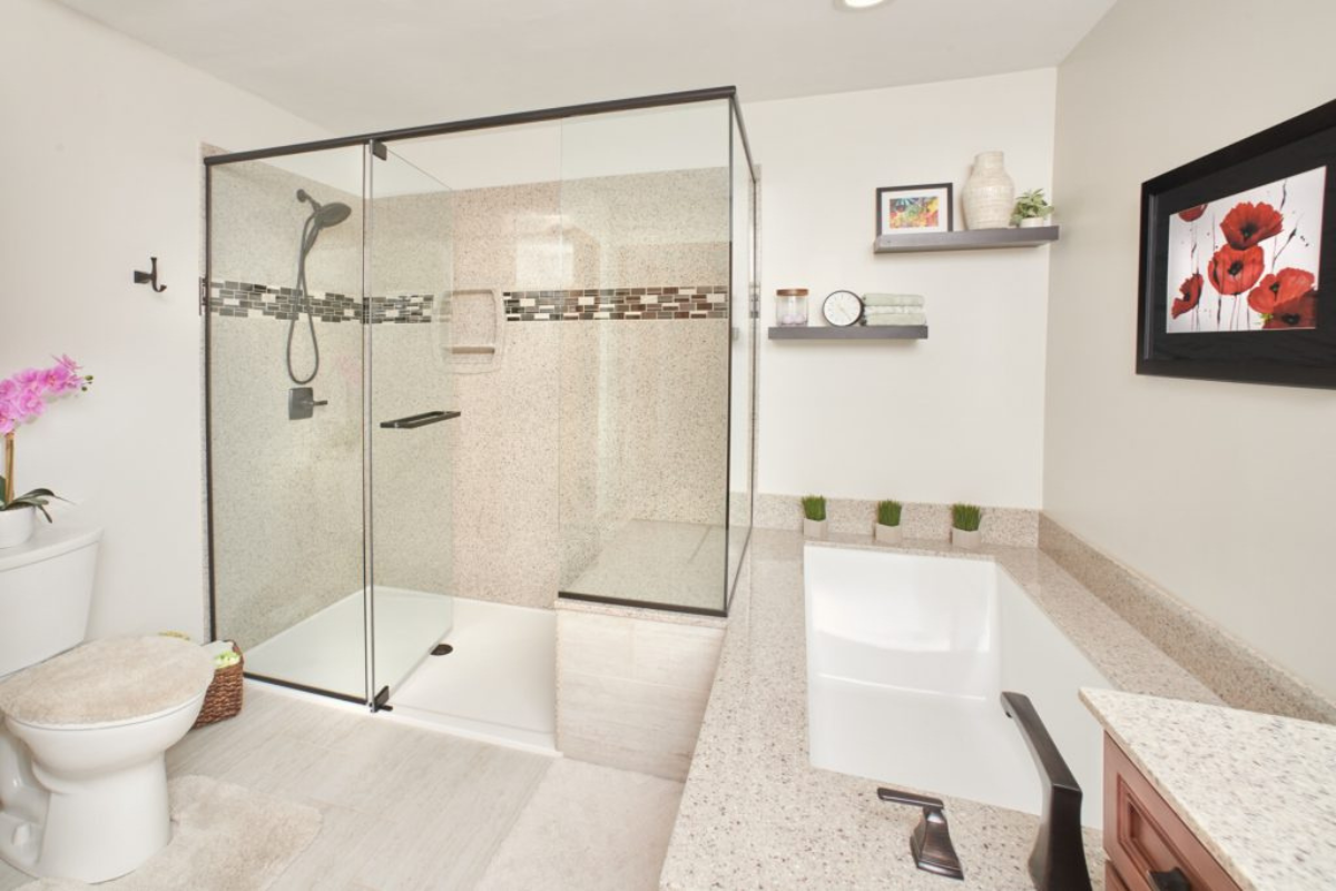 Modern bathroom design featuring a glass shower enclosure, stylish fixtures, a freestanding bathtub, and decorative elements like potted plants and artwork, showcasing J.T. McDermott Remodeling Contractors' expertise in bathroom renovations.